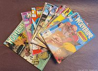 Fanned stack of Wolverine comic books showing multiple covers