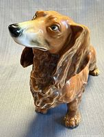 Front angled view of brown porcelain dachshund figurine