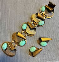 Front view of copper bracelet and earrings showing cabochons and design