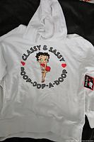 Full view of white hoodie with front graphic and hood