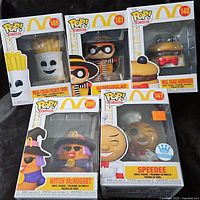 Front view of all five boxed Funko Pop figures
