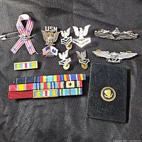 All items laid out: pins, ribbons, wallet