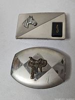Front view of both belt buckles showing designs