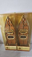 Front view of two boxed speedboat ornaments