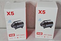 Front view of two sealed X5 HD WiFi camera boxes