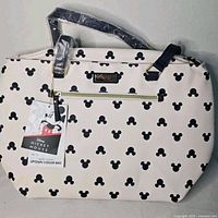Front view showing Mickey print, tag, exterior zipper pocket