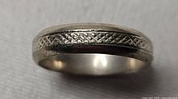 Side view of sterling silver band showing etched pattern