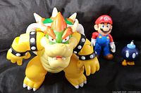 Bowser, Mario and Bob-omb figures on black background