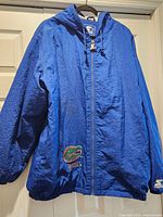Front view of blue Starter Florida Gators jacket on hanger