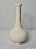 Front view of off-white Royal Haeger bud vase
