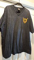 Full view of black Harley-Davidson V-neck T-shirt on hanger