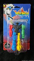 Front of sealed Voltron eraser pack showing five colored erasers