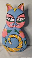 Front view of entire painted wooden cat figure