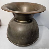 Side view of brass spittoon showing patina and shape