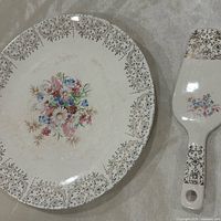top view of plate and server showing floral design and gold trim