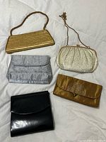 Group shot of all five evening bags showing colors and styles