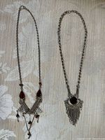 Both necklaces laid flat showing overall design and length