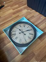 Clock in shallow turquoise box, full view