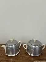 Sugar bowl and creamer side by side, frontal view
