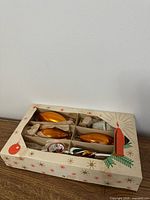 Closed box showing star pattern and visible ornaments through window