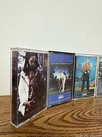 Close-up left three tapes: Lenny Kravitz and two Elton John cassettes