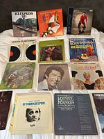 Overhead view of 12 LPs laid out showing front covers and artist names
