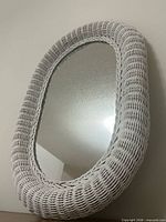 Front view of oval wicker rattan mirror