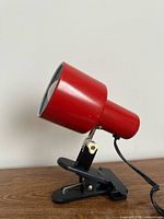 Full side view of red clamp lamp lit