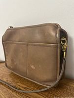 Front view showing exterior slip pocket, leather finish and blemishes