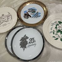 Group of five plates displaying designs and rims