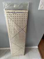 Board standing upright in plastic, full view