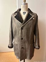 Front view of shearling leather coat on mannequin