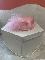 Fascinator on hat box showing overall style and box