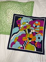 Both scarves laid flat showing full patterns