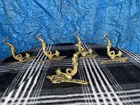 All five brass hooks displayed upright