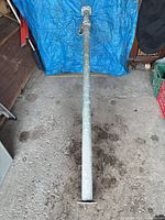 Full length view of galvanized adjustable beam on floor