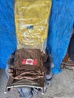 Yellow Woods Explorer backpack in plastic on aluminum frame, brown World Famous pack below