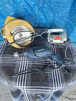 All three corded Black & Decker tools on blanket