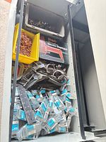 Top view of drawer showing staple gun box, bins of fasteners, clamps, screw packs
