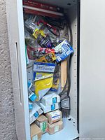 Overall view of drawer full of hardware and tools