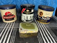 Four tins grouped on patterned surface