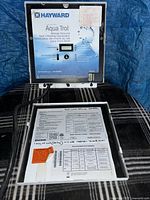 Front view of Hayward Aqua Trol control box open showing display and interior label
