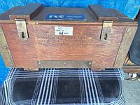 front view of wooden crate showing stamp and hardware