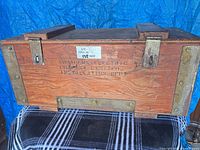 Front of wooden crate showing branding and hardware