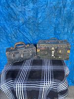 Two Northern Telecom cases side by side on blanket