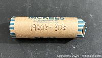 Full view of paper coin roll showing handwritten "1920s-30s".