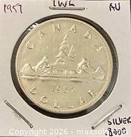 Reverse of 1957 Canadian silver dollar showing Voyageur canoe design, year 1957 visible