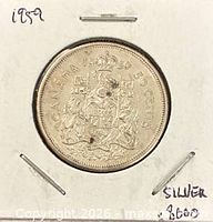 Reverse of 1959 Canadian 50-cent coin showing coat of arms, date and denomination