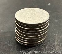 Stack of ten Canadian nickel dollars showing reeded edges