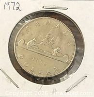 Reverse side Voyageur design of 1972 Canadian dollar in coin flip